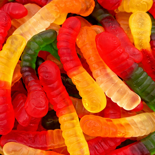 Colorful gummy worms in red, orange, green, and yellow.